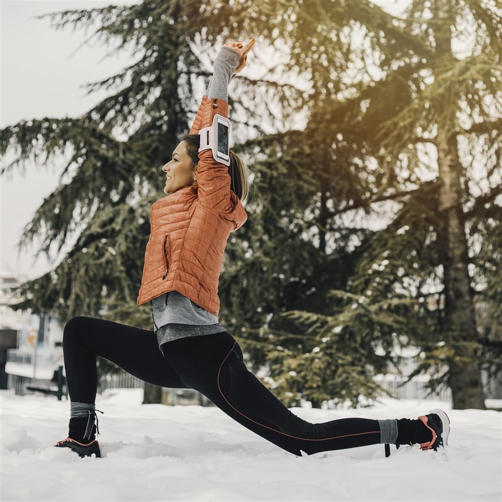 Woman exercising outside in the snow